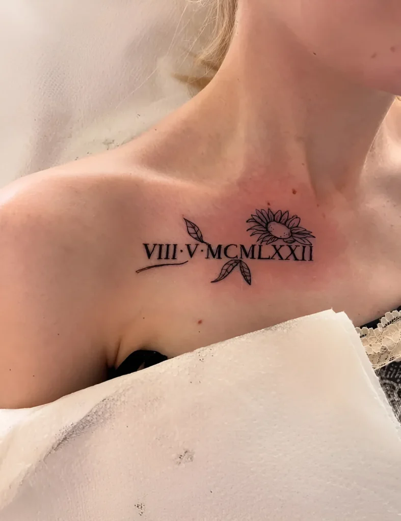 Black and white collarbone tattoo with a sunflower and Roman numerals VIII-V-MCMLXXII