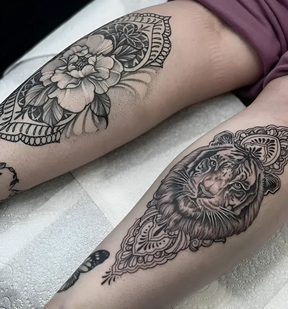 Black and white calf tattoo: realistic tiger head enclosed in a complex mandala ornament, with dot shading for the background.