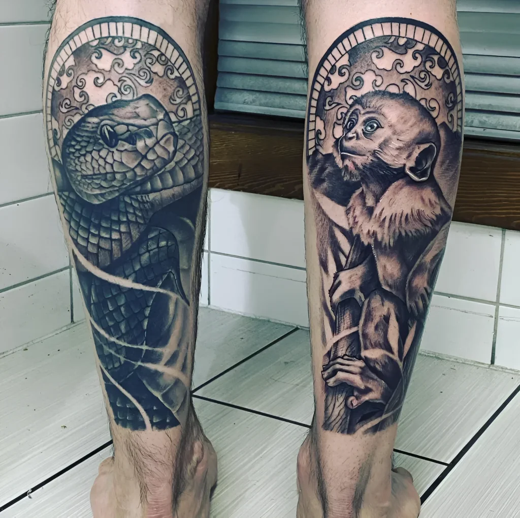 Black and grey tattoo on calves: realistic depiction of a snake and monkey heads, enclosed in a circle with oriental ornament.