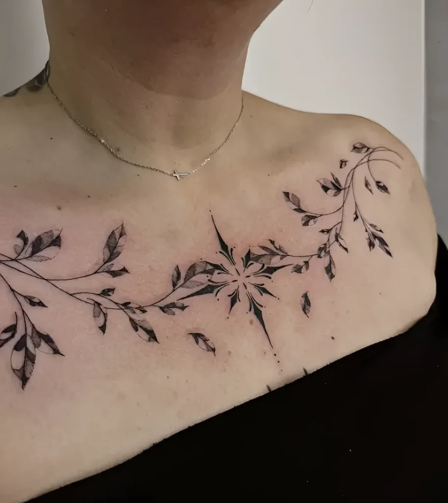 Black and white collarbone tattoo of a branch with leaves, transitioning into a stylized compass, done in dotwork technique.