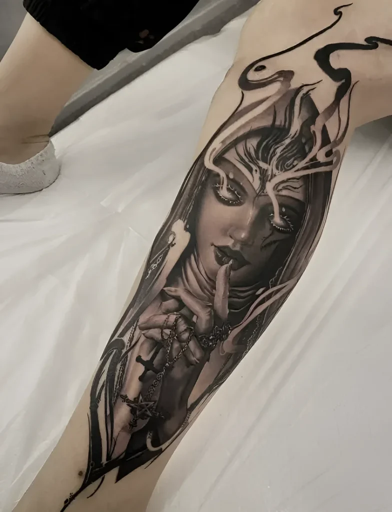 Black and white realistic calf tattoo depicting a girl with her finger to her lips, surrounded by dark wings and glowing elements.
