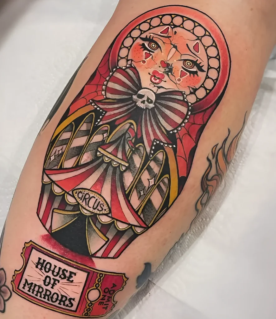Photo of a calf tattoo: image of a circus performer in a red dress with a skull, done in old school style with bright colors and clear outlines.