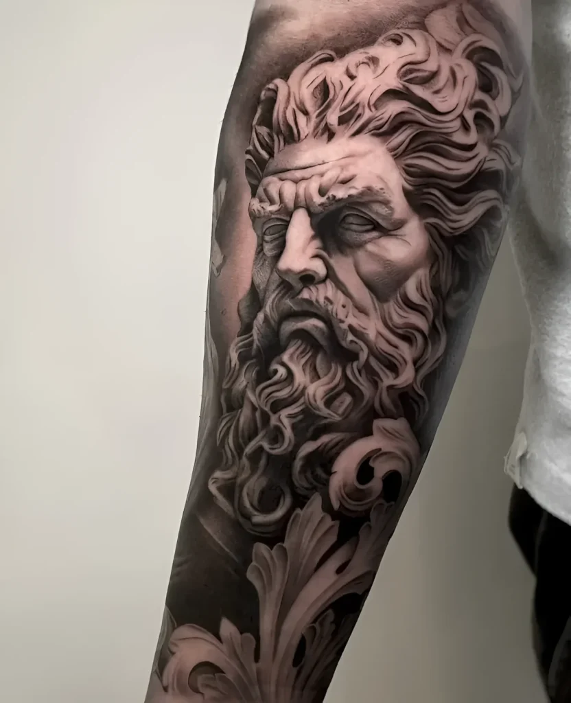 Black and grey realistic tattoo of Poseidon's head with waves and floral ornament on a muscular forearm