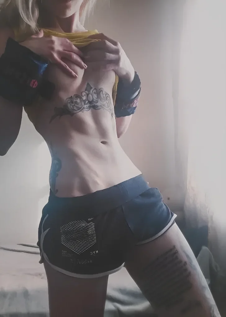 Photo of a tattoo under the female breast in graphic style: abstract pattern emphasizing the body's curves