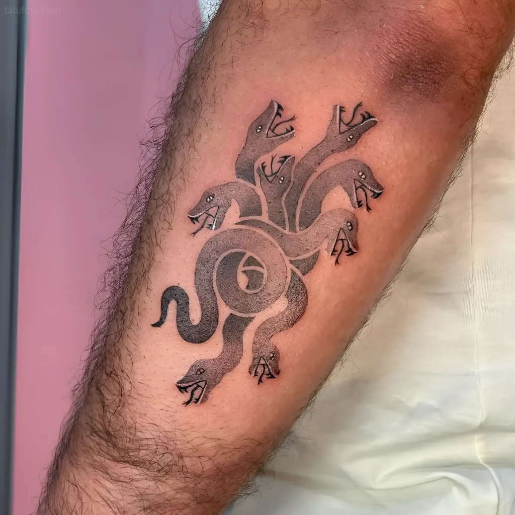 Tattoo of a multi-headed Hydra in graphic minimalism style on the forearm