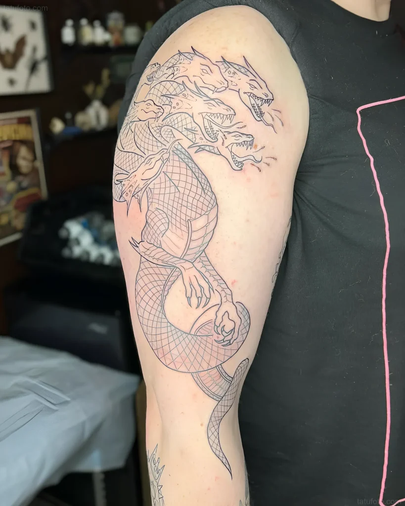 Outline tattoo of a multi-headed Hydra on the arm, demonstrating the complexity of the mythological creature