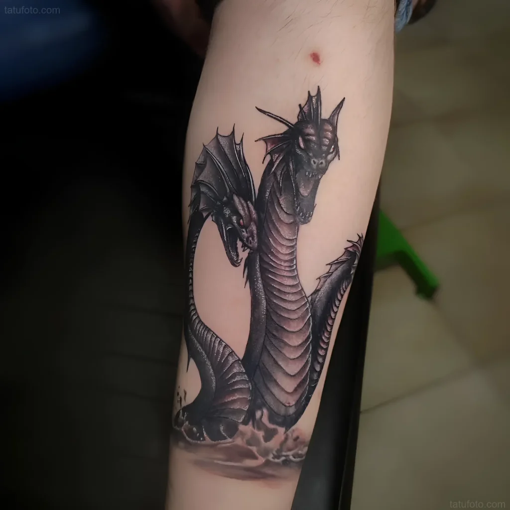 Detailed tattoo of the Lernean Hydra in dark tones on the forearm