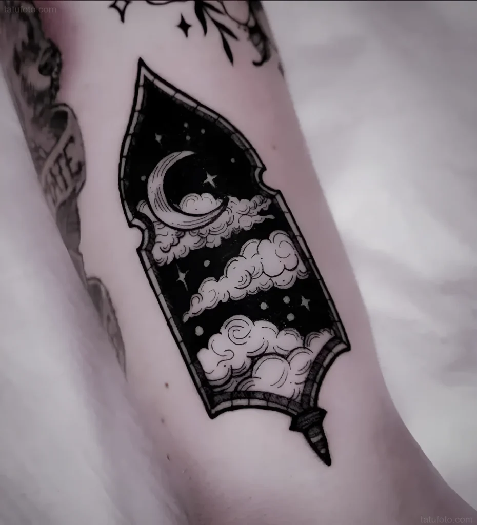 Black and white portal tattoo with a night sky, moon, and clouds