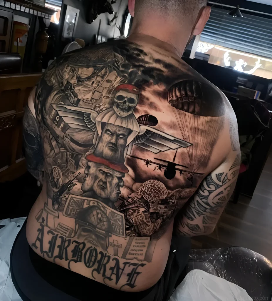 背部大型纹身,描绘伞兵行动场景,带有降落伞、直升机和'AIRBORNE'字样