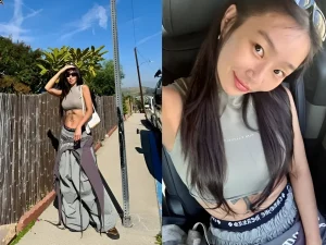 Hyolyn в облегающем топе и спортивных штанах, демонстрирующая татуировку на животе.