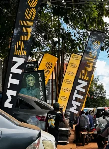 MTN Pulse banners and promotional materials at the LinusTats Tattoo Party event in Uganda, featuring bold typography and youth culture branding.